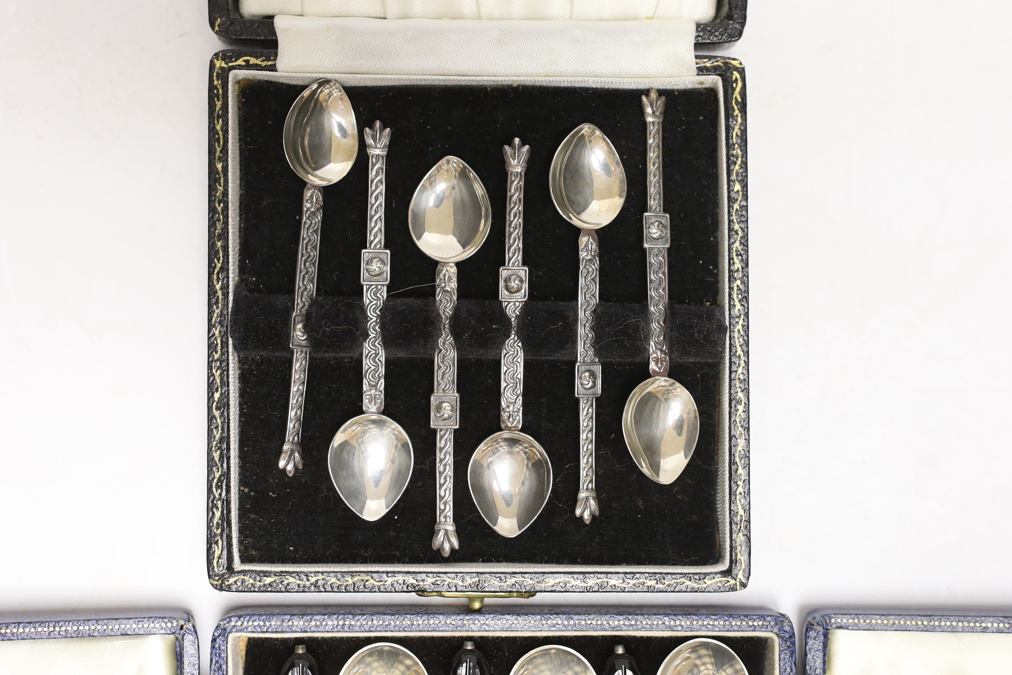 Two cased sets of six Elizabeth II silver coffee spoons, including bean end and Celtic style.